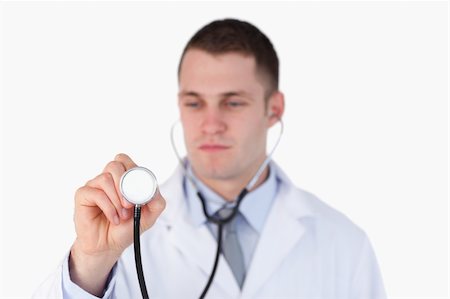simsearch:400-05710403,k - Close up of doctor looking at his stethoscope on white background Stock Photo - Budget Royalty-Free & Subscription, Code: 400-05710968