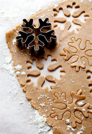 simsearch:400-05721521,k - Making gingerbread cookies for Christmas. Gingerbread dough with snowflake shapes. Stock Photo - Budget Royalty-Free & Subscription, Code: 400-05711734