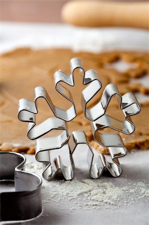 simsearch:400-05721521,k - Making gingerbread cookies for Christmas. Gingerbread dough with star shapes and a snowflake cutter. Stock Photo - Budget Royalty-Free & Subscription, Code: 400-05711735