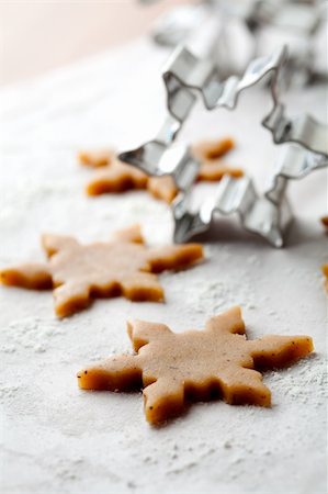 simsearch:400-05721521,k - Making gingerbread cookies for Christmas. Gingerbread dough with star shapes and a cutter. Stock Photo - Budget Royalty-Free & Subscription, Code: 400-05711737