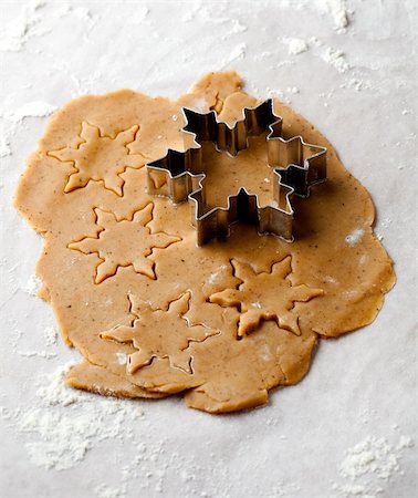 simsearch:400-05721521,k - Making gingerbread cookies for Christmas. Gingerbread dough with star shapes and a cutter. Stock Photo - Budget Royalty-Free & Subscription, Code: 400-05711738