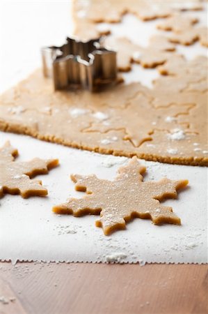 simsearch:400-05721521,k - Making gingerbread cookies for Christmas. Gingerbread dough with star shapes and a cutter. Stock Photo - Budget Royalty-Free & Subscription, Code: 400-05711732