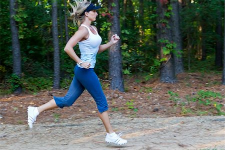 A young female jogger running through the woods Stock Photo - Budget Royalty-Free & Subscription, Code: 400-05712927