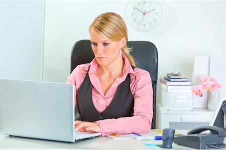 simsearch:400-05729275,k - Business woman working on laptop at office desk Stock Photo - Budget Royalty-Free & Subscription, Code: 400-05713270