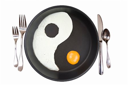 YIn-Yang eggs in a frying pan over white Stock Photo - Budget Royalty-Free & Subscription, Code: 400-05724204