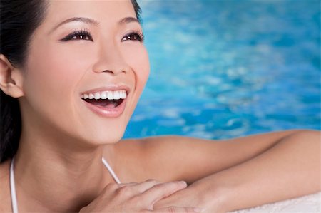 simsearch:400-06422339,k - A beautiful sexy young Chinese Asian Oriental woman wearing a bikini and relaxing on the side of a swimming pool. Foto de stock - Super Valor sin royalties y Suscripción, Código: 400-05727752