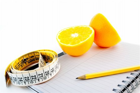 food specialist - detail an orange with a measuring tape on notepad Photographie de stock - Aubaine LD & Abonnement, Code: 400-05728496