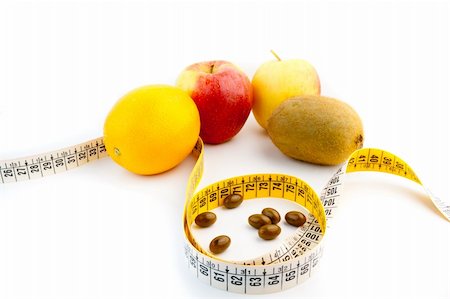 food specialist - detail of pills and fruit  with measuring tape Photographie de stock - Aubaine LD & Abonnement, Code: 400-05728493