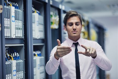 simsearch:400-04239432,k - young handsome business man  engeneer in datacenter server room Stock Photo - Budget Royalty-Free & Subscription, Code: 400-05728783