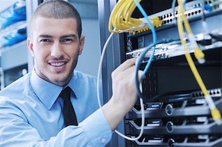 young handsome business man  engeneer in datacenter server room Stock Photo - Budget Royalty-Free & Subscription, Code: 400-05728907