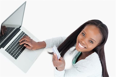 Smiling woman booking flight online against a white background Stock Photo - Budget Royalty-Free & Subscription, Code: 400-05729193
