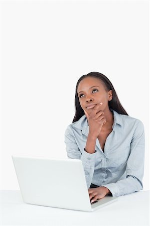 simsearch:400-05729275,k - Portrait of a thoughtful businesswoman using a laptop against a white background Stock Photo - Budget Royalty-Free & Subscription, Code: 400-05729255