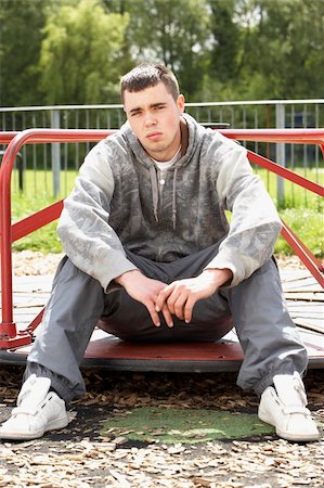 simsearch:400-05729552,k - Young Man Sitting In Playground Stock Photo - Budget Royalty-Free & Subscription, Code: 400-05729521