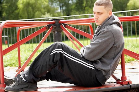 simsearch:400-05729552,k - Young Man Sitting In Playground Stock Photo - Budget Royalty-Free & Subscription, Code: 400-05729533