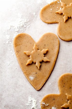 simsearch:400-05721521,k - Making gingerbread cookies for Christmas. Gingerbread dough with heart shapes Stock Photo - Budget Royalty-Free & Subscription, Code: 400-05721523