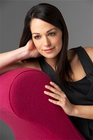 Studio Portrait Of Woman Relaxing On Pink Chaise Longue Stock Photo - Budget Royalty-Free & Subscription, Code: 400-05734940