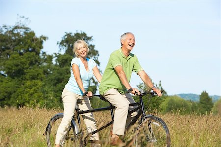 Mature couple riding tandem Stock Photo - Budget Royalty-Free & Subscription, Code: 400-05736042