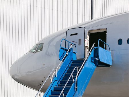 Big passenger airplane parked near hangar Stock Photo - Budget Royalty-Free & Subscription, Code: 400-05736667