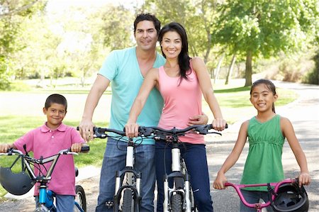 family mountain biking - Young Family Riding Bikes In Park Stock Photo - Budget Royalty-Free & Subscription, Code: 400-05737825