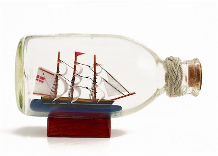 ship in a bottle - Decorative ship in glass bottle on wooden support Stock Photo - Budget Royalty-Free & Subscription, Code: 400-05738509