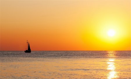 simsearch:400-07748817,k - Golden sunset on a sea with silhouette of a yacht. Stock Photo - Budget Royalty-Free & Subscription, Code: 400-05738807
