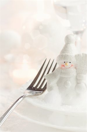 simsearch:400-05693119,k - Christmas table setting. Fork and knife in elegant holiday setting with snow and white ornaments Stock Photo - Budget Royalty-Free & Subscription, Code: 400-05739493
