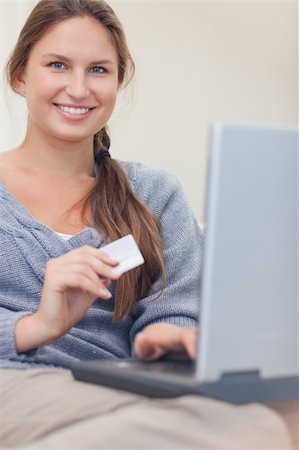 simsearch:400-04410667,k - Portrait of a smiling woman booking her holidays online in her living room Stock Photo - Budget Royalty-Free & Subscription, Code: 400-05739921