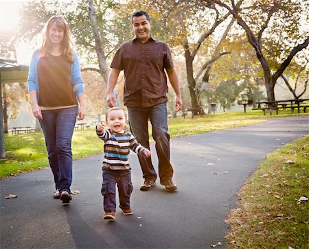 Happy Young Mixed Race Ethnic Family Walking In The Park. Stock Photo - Budget Royalty-Free & Subscription, Code: 400-05732075