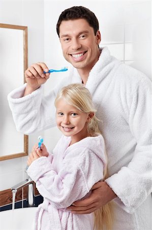 family bathroom mirror - Father and daughter brushing their teeth in the bathroom Stock Photo - Budget Royalty-Free & Subscription, Code: 400-05732852