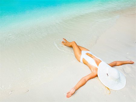 simsearch:628-00919176,k - Beautiful woman sunbathing on the sandy beach. Stock Photo - Budget Royalty-Free & Subscription, Code: 400-05733437