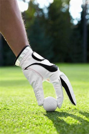 simsearch:400-05753062,k - Hand puts the ball on the golf course Stock Photo - Budget Royalty-Free & Subscription, Code: 400-05733810