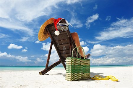 Woman relaxing on the beach in santa's hat Stock Photo - Budget Royalty-Free & Subscription, Code: 400-05744794