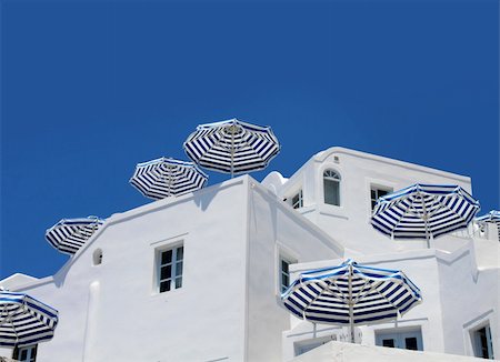 Sunshade umbrellas on white holiday apartment balcony blue sky background Stock Photo - Budget Royalty-Free & Subscription, Code: 400-05744976