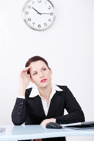 simsearch:400-05729275,k - Front view of a wondering business woman sitting behind the desk with a clock in the background. Stock Photo - Budget Royalty-Free & Subscription, Code: 400-05745331