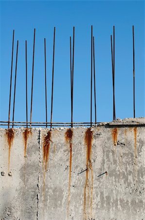 reinforcement - Old reinforcing steel protruding from the concrete. Blue sky background Stock Photo - Budget Royalty-Free & Subscription, Code: 400-05745353