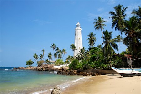 simsearch:400-05745636,k - Beautiful white lighthouse Dondra Head, the southest cape of Sri Lanka - seen from the beach. The lighthouse is also a highest (161 feet) not only on the island but also in the whole Asia Stock Photo - Budget Royalty-Free & Subscription, Code: 400-05745636