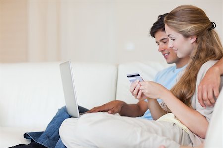 simsearch:400-04410667,k - Couple shopping online in their living room Stock Photo - Budget Royalty-Free & Subscription, Code: 400-05746679