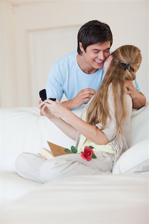 simsearch:400-04739802,k - Portrait of a man offering a jewel to his girlfriend in their living room Stock Photo - Budget Royalty-Free & Subscription, Code: 400-05746685