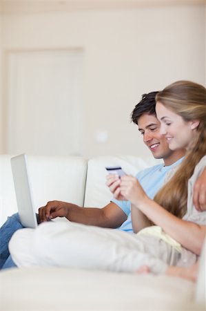 simsearch:400-04410667,k - Portrait of a couple shopping online in their living room Stock Photo - Budget Royalty-Free & Subscription, Code: 400-05746680