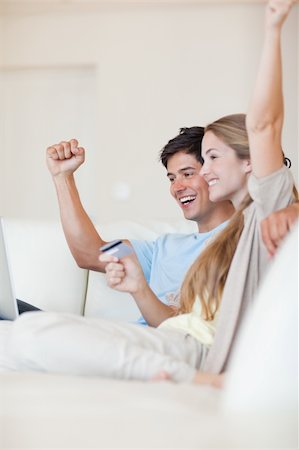 simsearch:400-04410667,k - Portrait of a successful couple shopping online in their living room Stock Photo - Budget Royalty-Free & Subscription, Code: 400-05746681
