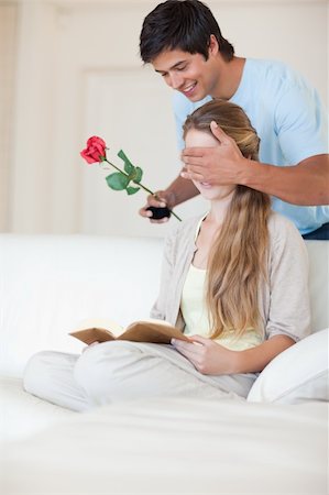 simsearch:400-04739802,k - Portrait of a man offering a rose to his girlfriend while she is reading Stock Photo - Budget Royalty-Free & Subscription, Code: 400-05746682