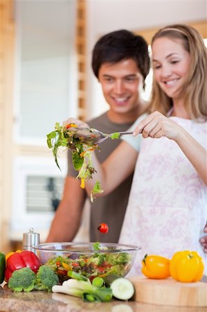 simsearch:400-05744780,k - Portrait of a charming couple making a salad in their kitchen Stock Photo - Budget Royalty-Free & Subscription, Code: 400-05746847