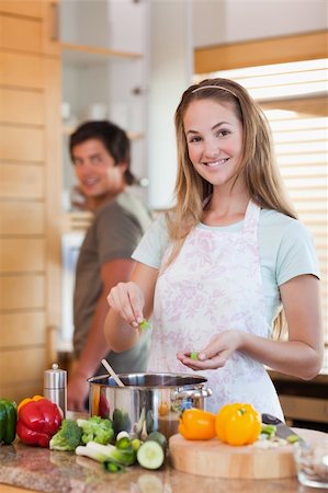 simsearch:400-05740111,k - Portrait of a smiling couple cooking in their kitchen Stock Photo - Budget Royalty-Free & Subscription, Code: 400-05746850