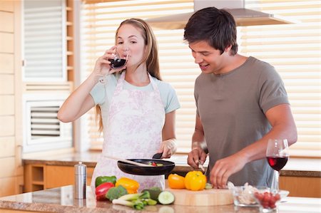 simsearch:400-05740111,k - Couple cooking dinner while drinking wine in their kitchen Stock Photo - Budget Royalty-Free & Subscription, Code: 400-05746869