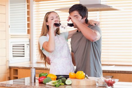 simsearch:400-05740111,k - Lovely couple drinking red wine in their kitchen Stock Photo - Budget Royalty-Free & Subscription, Code: 400-05746874