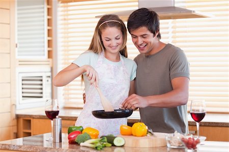simsearch:400-05740111,k - Couple cooking dinner while drinking red wine in their kitchen Stock Photo - Budget Royalty-Free & Subscription, Code: 400-05746870