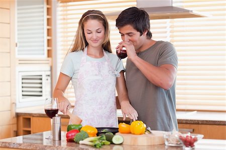 simsearch:400-05740111,k - Young couple cooking dinner while drinking red wine in their kitchen Stock Photo - Budget Royalty-Free & Subscription, Code: 400-05746871