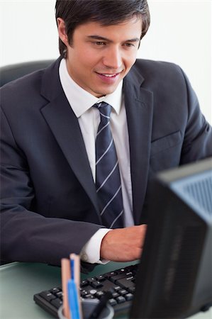simsearch:400-05748170,k - Portrait of a young businessman working with a computer in his office Stock Photo - Budget Royalty-Free & Subscription, Code: 400-05746922