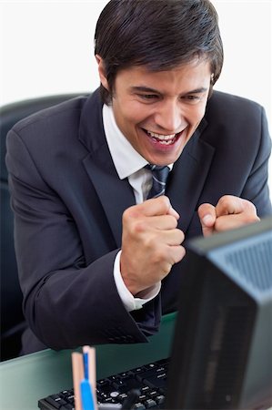 simsearch:400-05748170,k - Portrait of a cheerful businessman working with a computer in his office Stock Photo - Budget Royalty-Free & Subscription, Code: 400-05746923