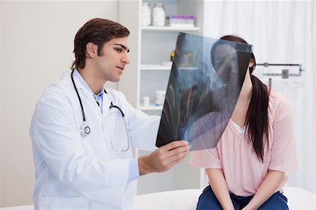 simsearch:400-05748252,k - Male doctor analyzing x-ray with his patient Stock Photo - Budget Royalty-Free & Subscription, Code: 400-05747048